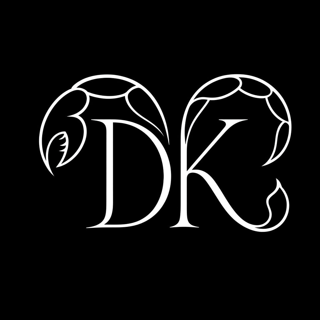 Keep Dreaming Scorpio approved mark — DK monogram with scorpion flourishes white on black